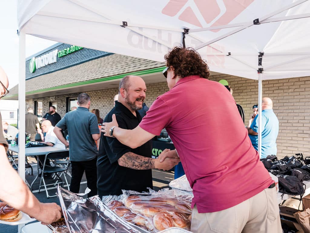 a group of people standing around a table